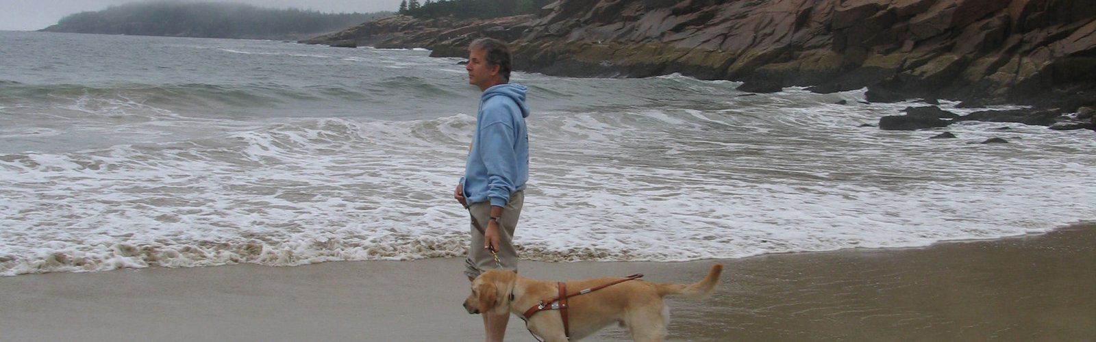 Mike and Seeing Eye dog, Miguel, at a Maine beach