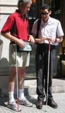 Mike showing BrailleNote GPS to a curious blind bypasser